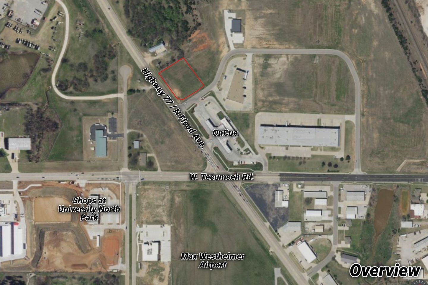 Aerial overview of the vacant parcel outlined in red on Highway 77 / N. Flood Avenue near W. Tecumseh Road, by an OnCue and the Shops at University North Park.