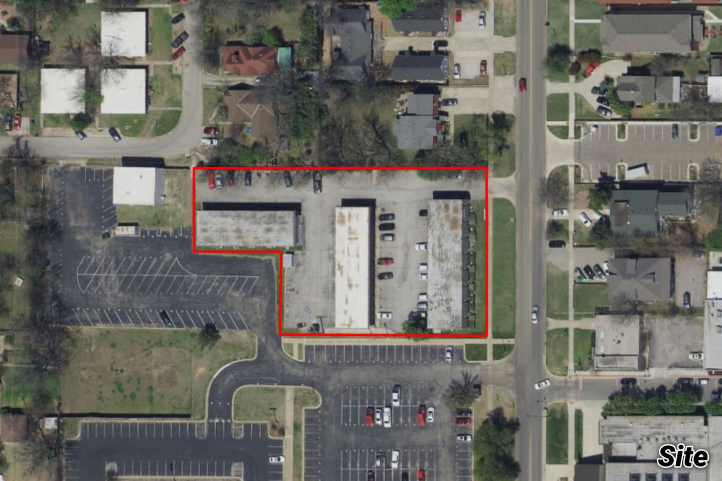 Aerial of the Campus Corner block outlined in red, with older buildings and a parking lot near the neighborhoods.
