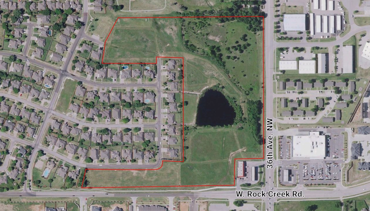Labeled aerial of the large tract outlined in red at 36th Avenue NW and W. Rock Creek Road, with a pond, ringed by neighborhoods.